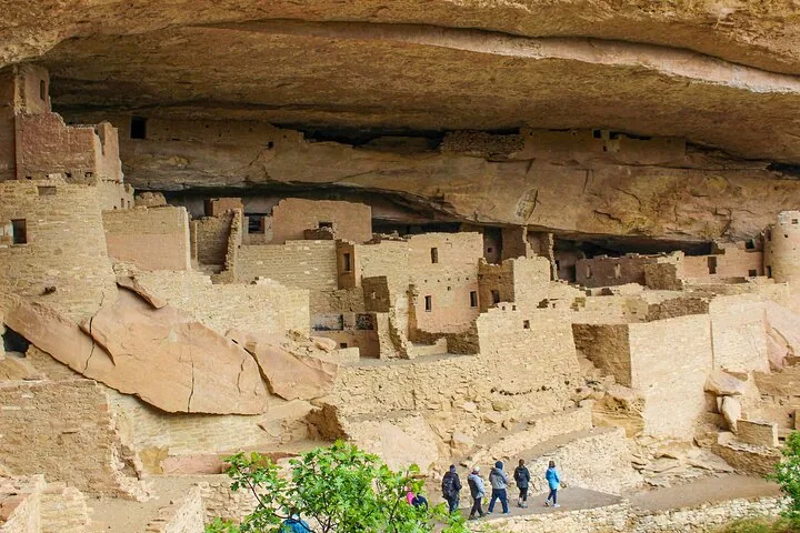 Tourists admire the well-preserved ancient stone dwellings in Cliff Palace.